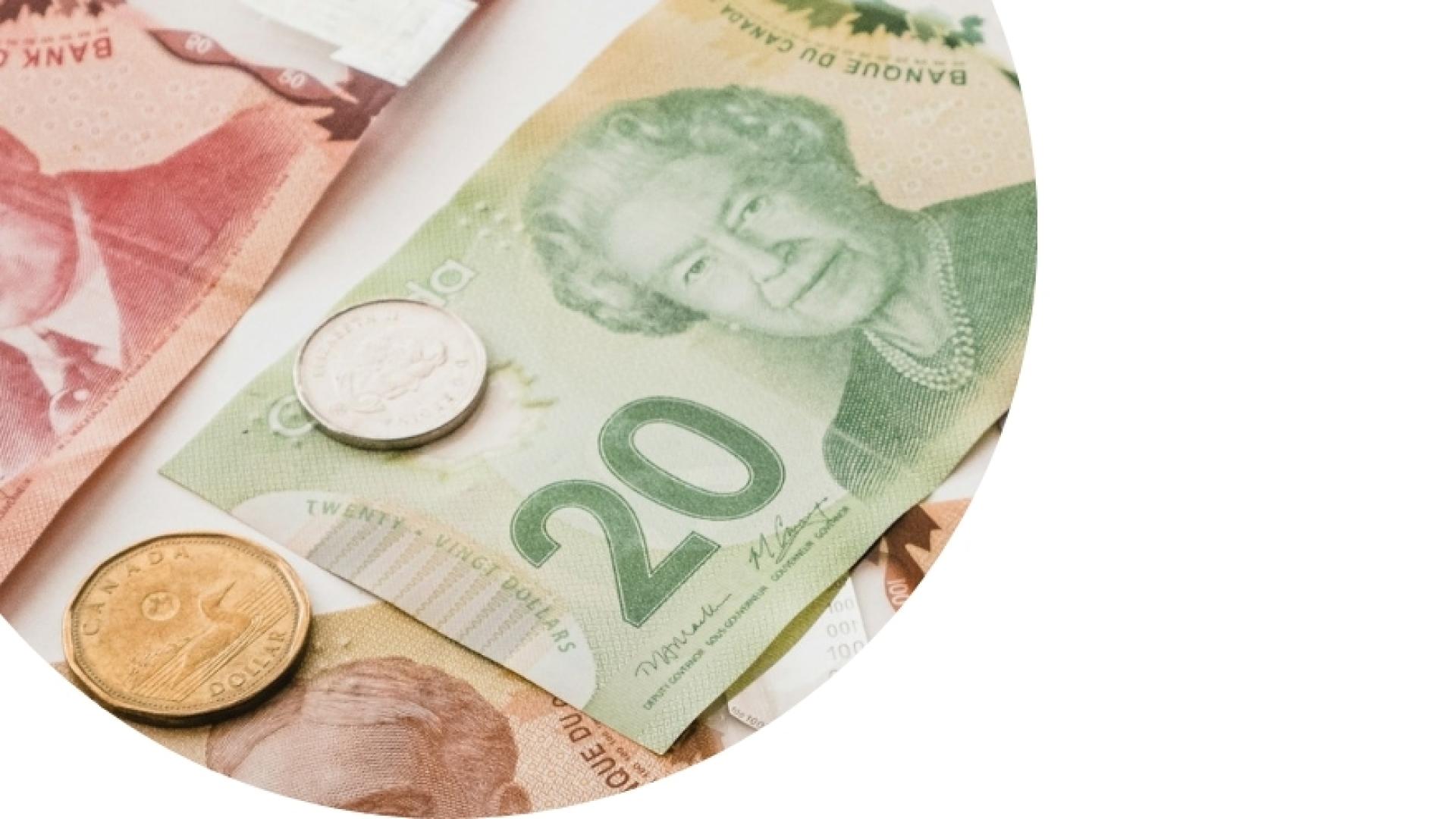 $20 bill with few coins on a table