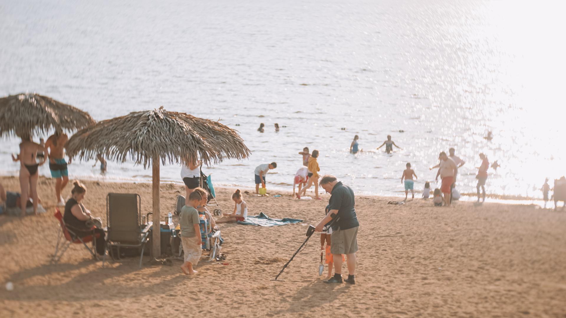 People swimming, relaxing, and enjoying the beach at L’Orignal Beach during Canada Day celebrations.