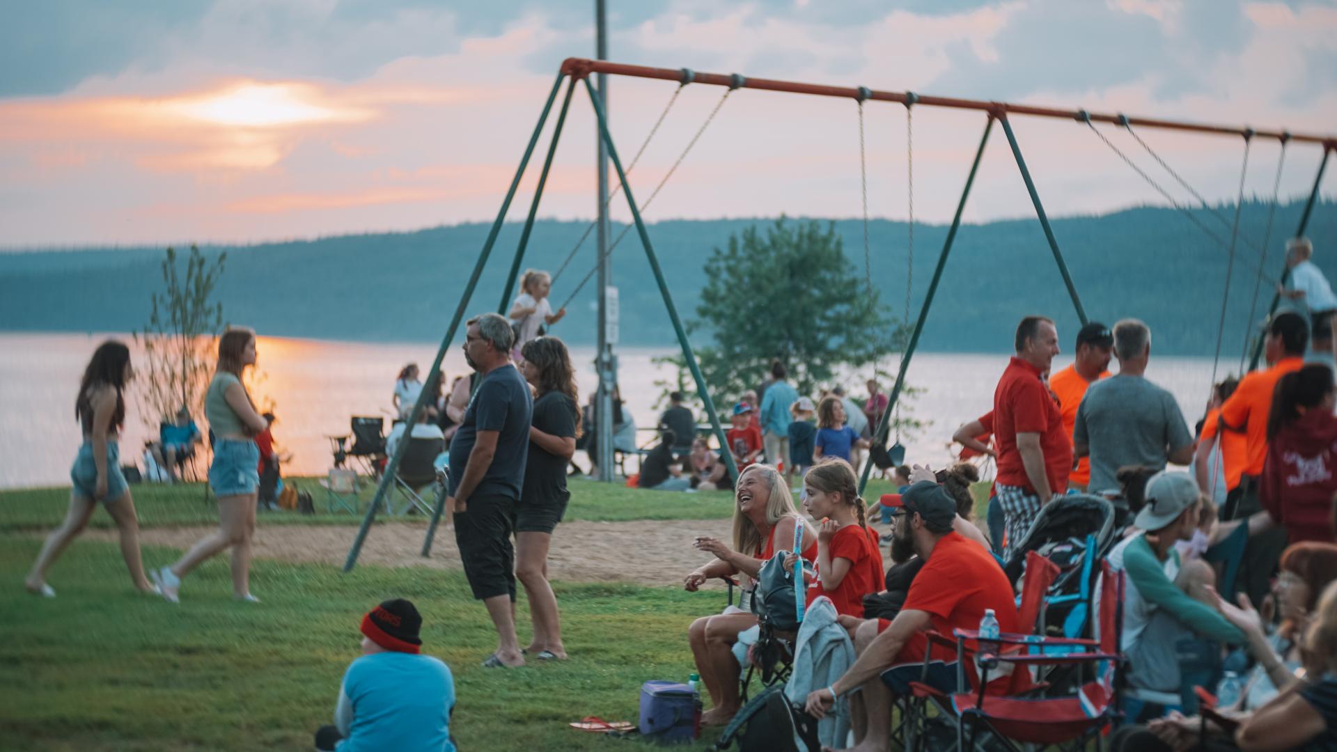 Residents and visitors gathering by the waterfront for evening festivities.