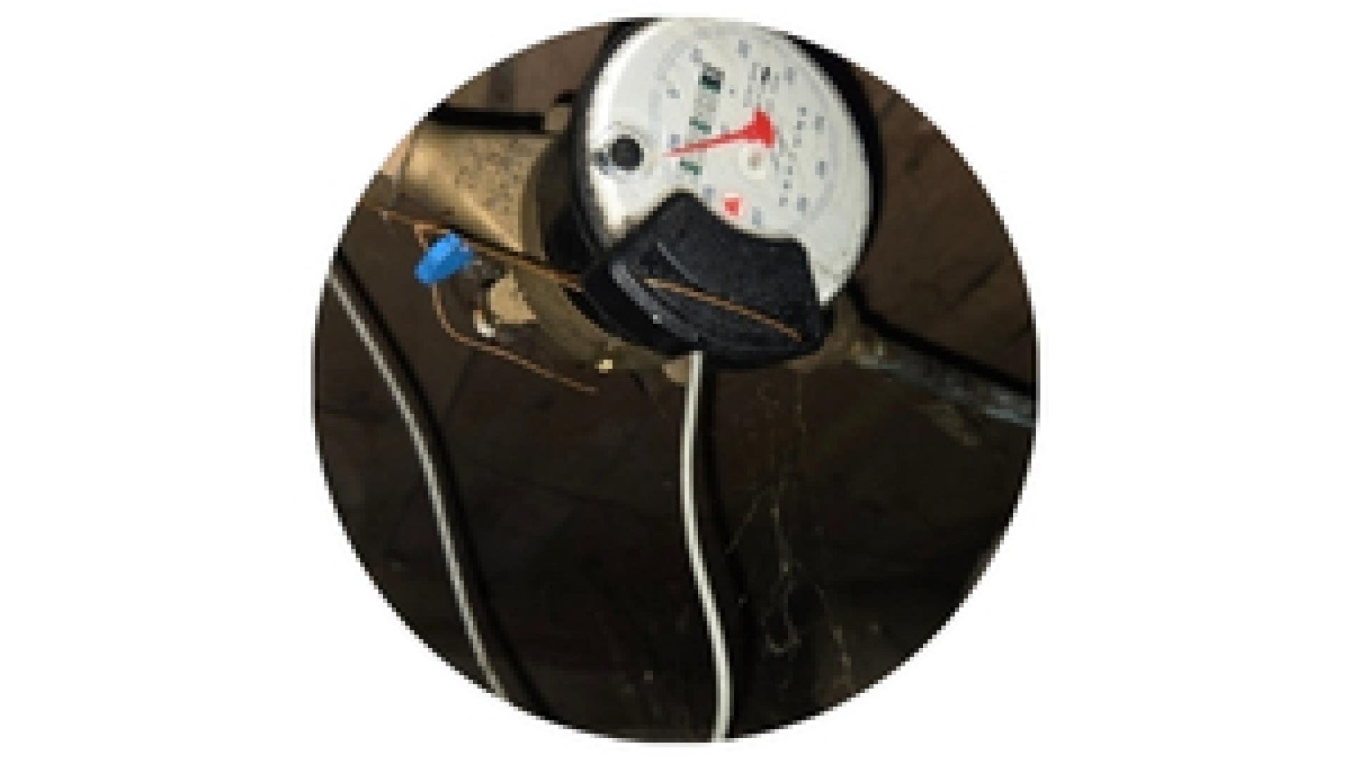 an old water meter in a crawl space in a basement