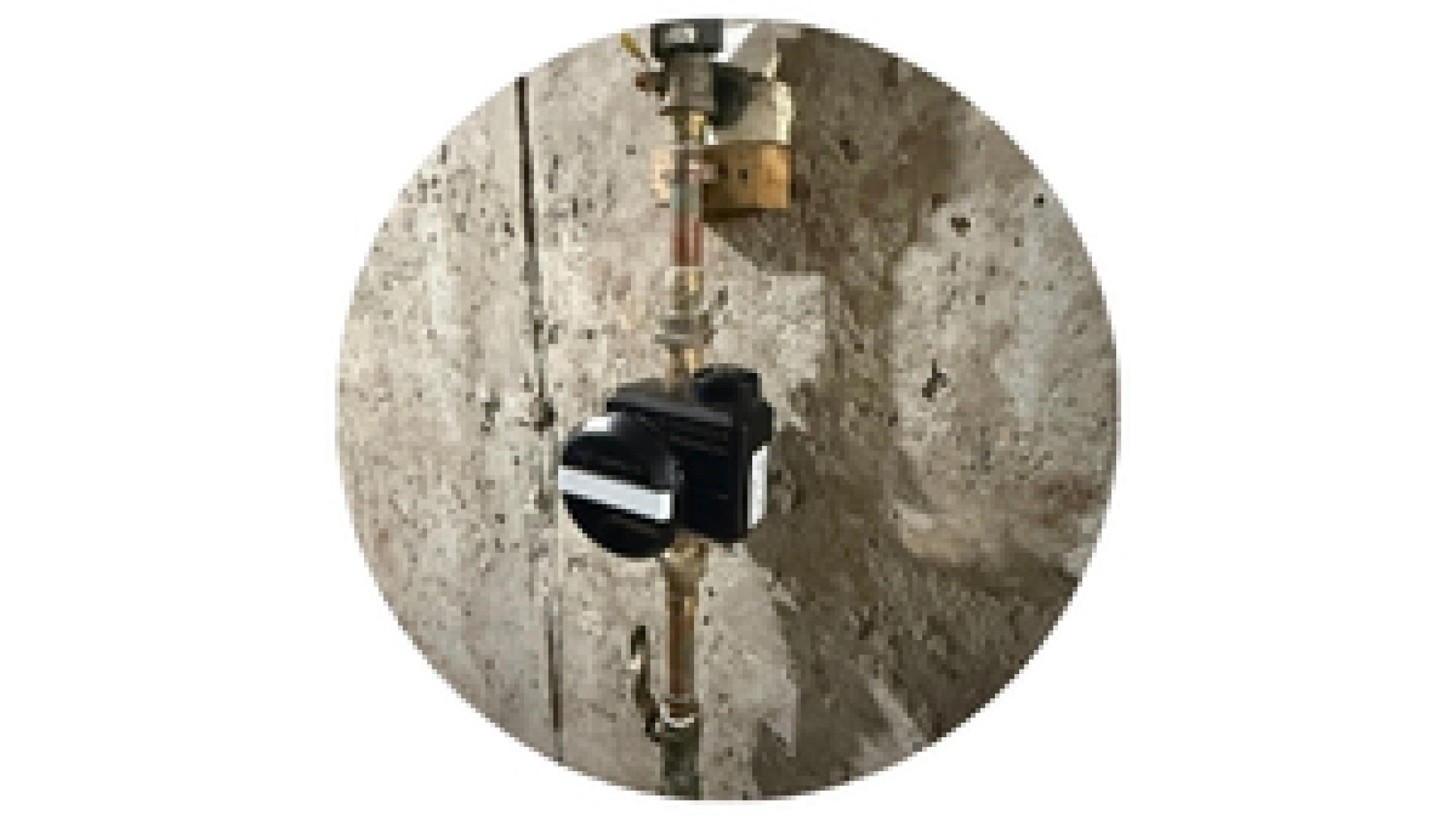 a new installed water meter on a pipe in a basement