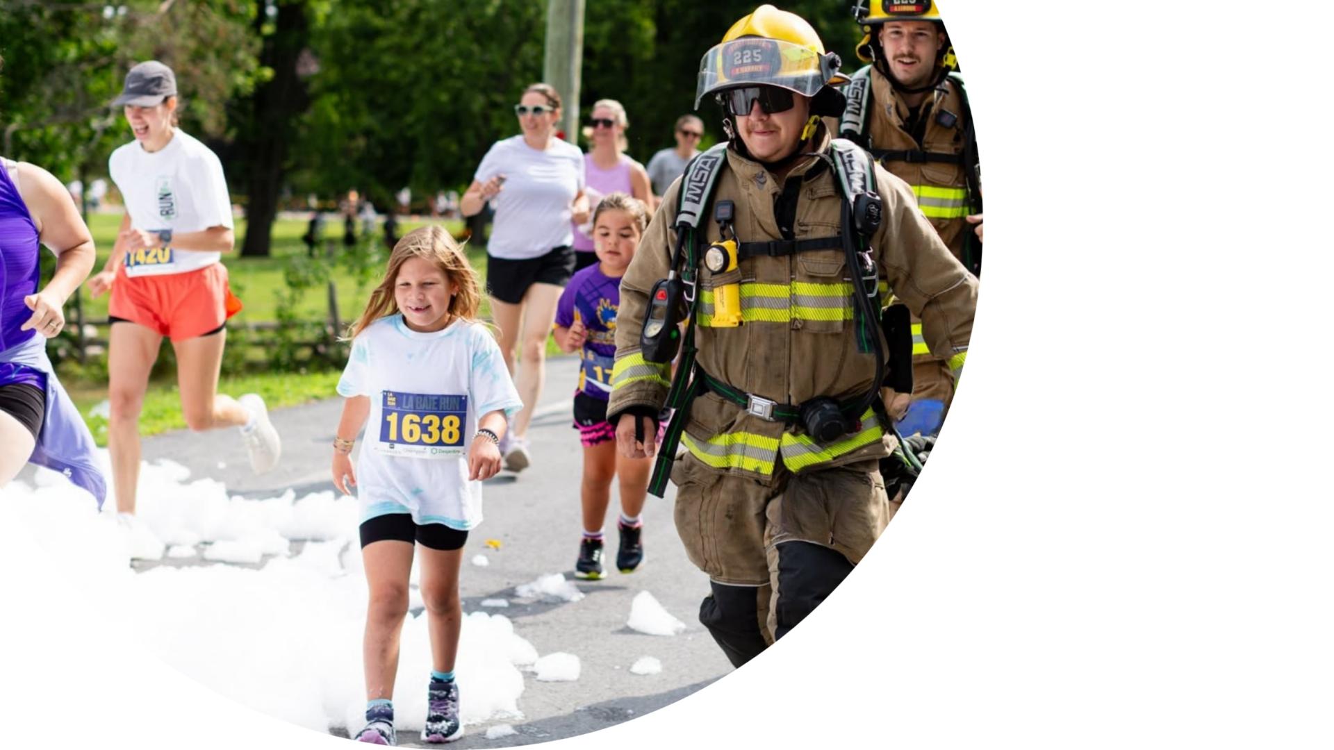firefighters with kids and adults participating in a community run with foam.