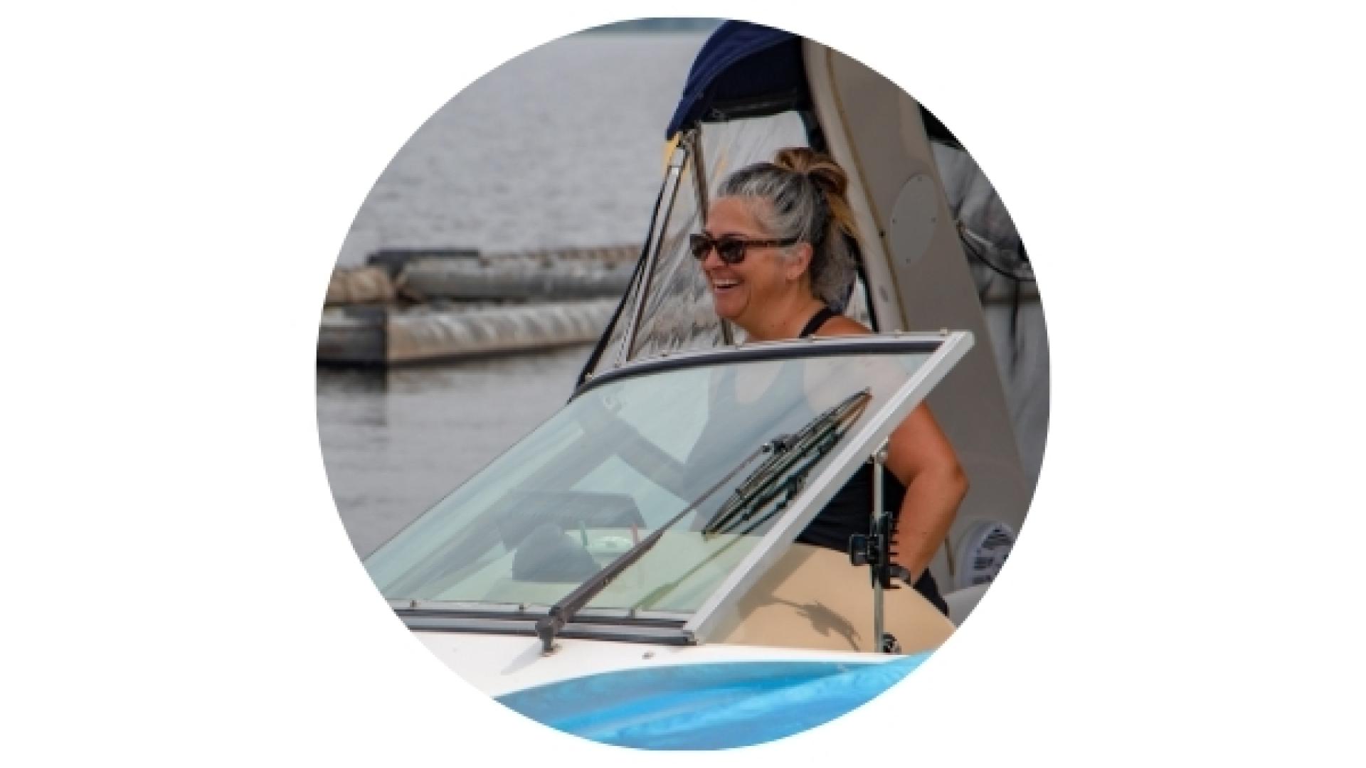Person seated in a recreational boat at the L’Orignal Marina, preparing to depart from the dock on the Ottawa River.