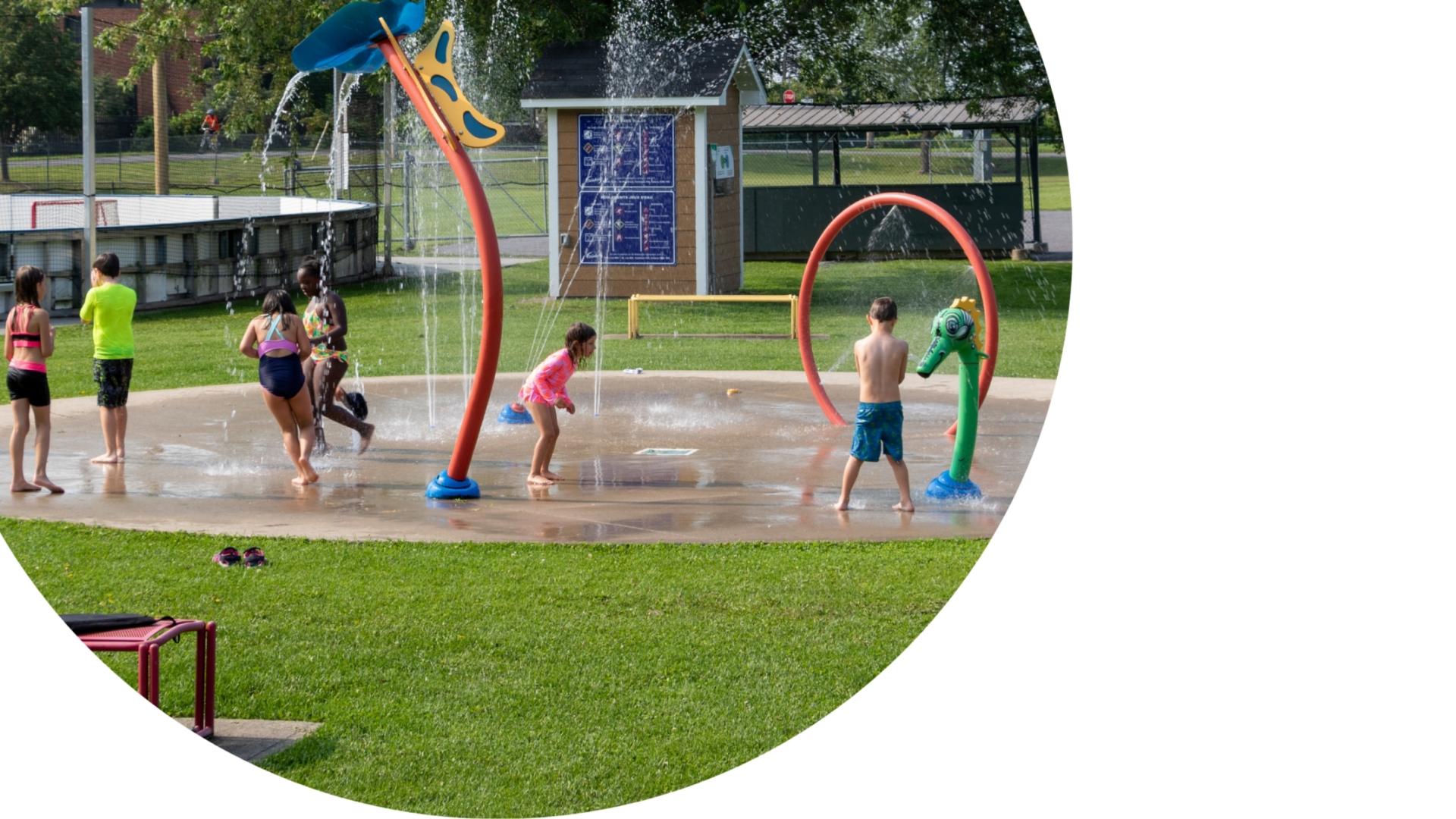 kids playing in a splash pad during a summer day