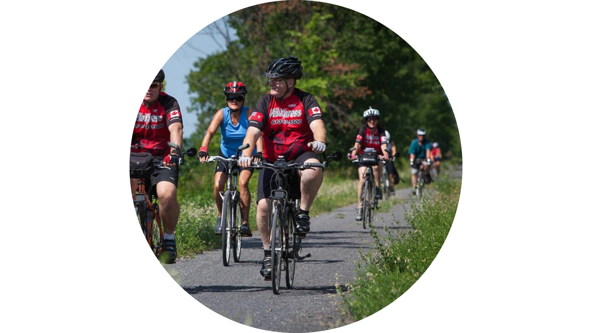 Cyclists riding along the Prescott and Russell Recreational Trail during a group cycling outing.