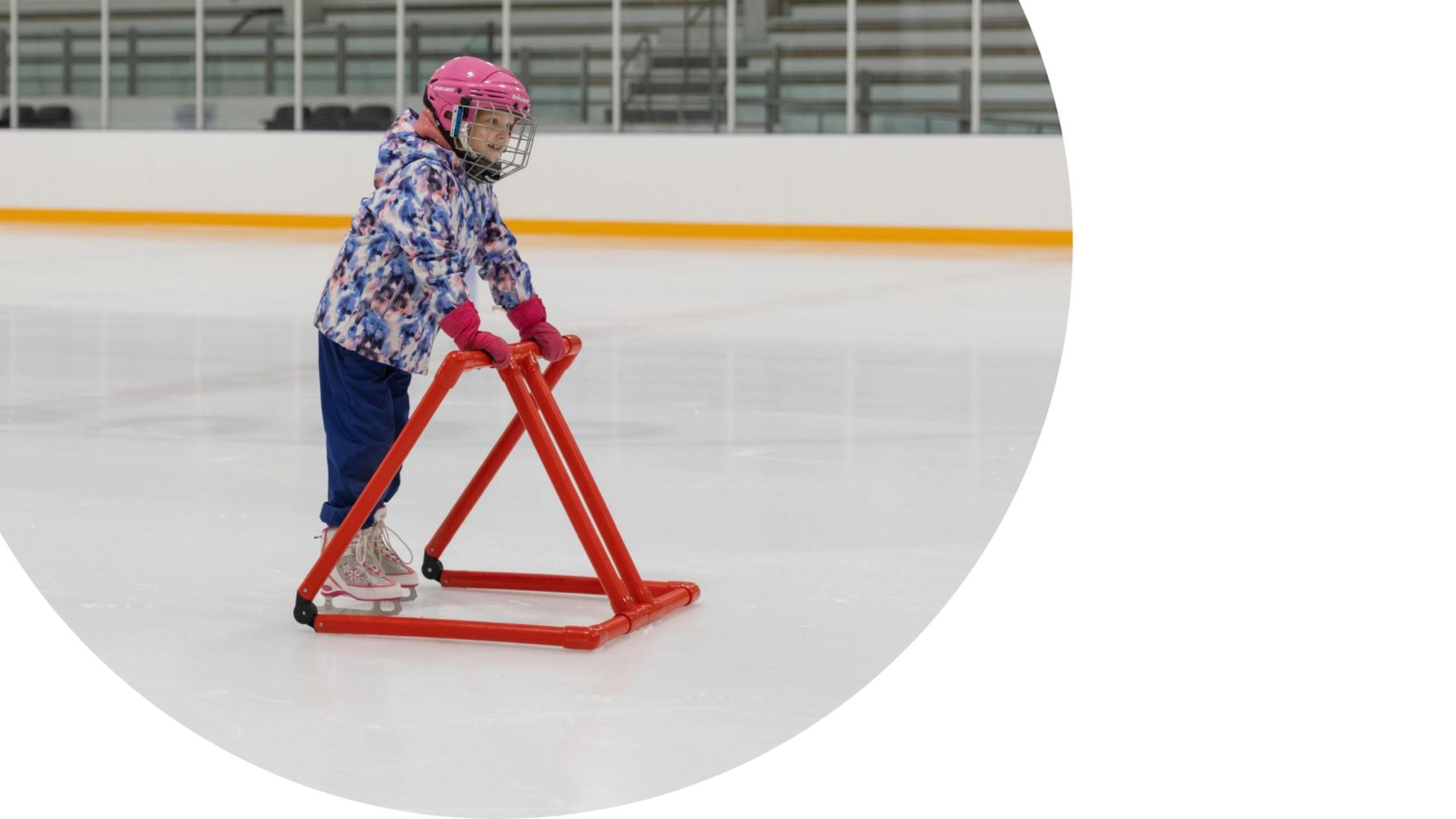 little girl learning to skate with a support