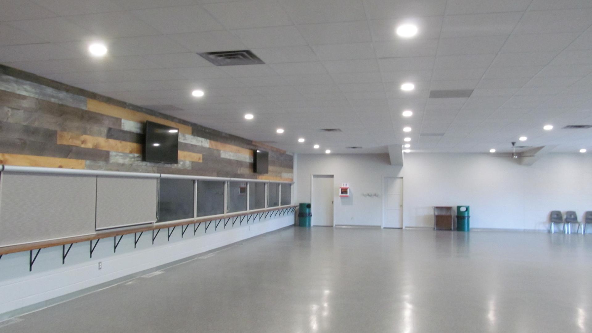 Large community hall with an open floor plan, bar counter, and flexible space for meetings, receptions, and events.