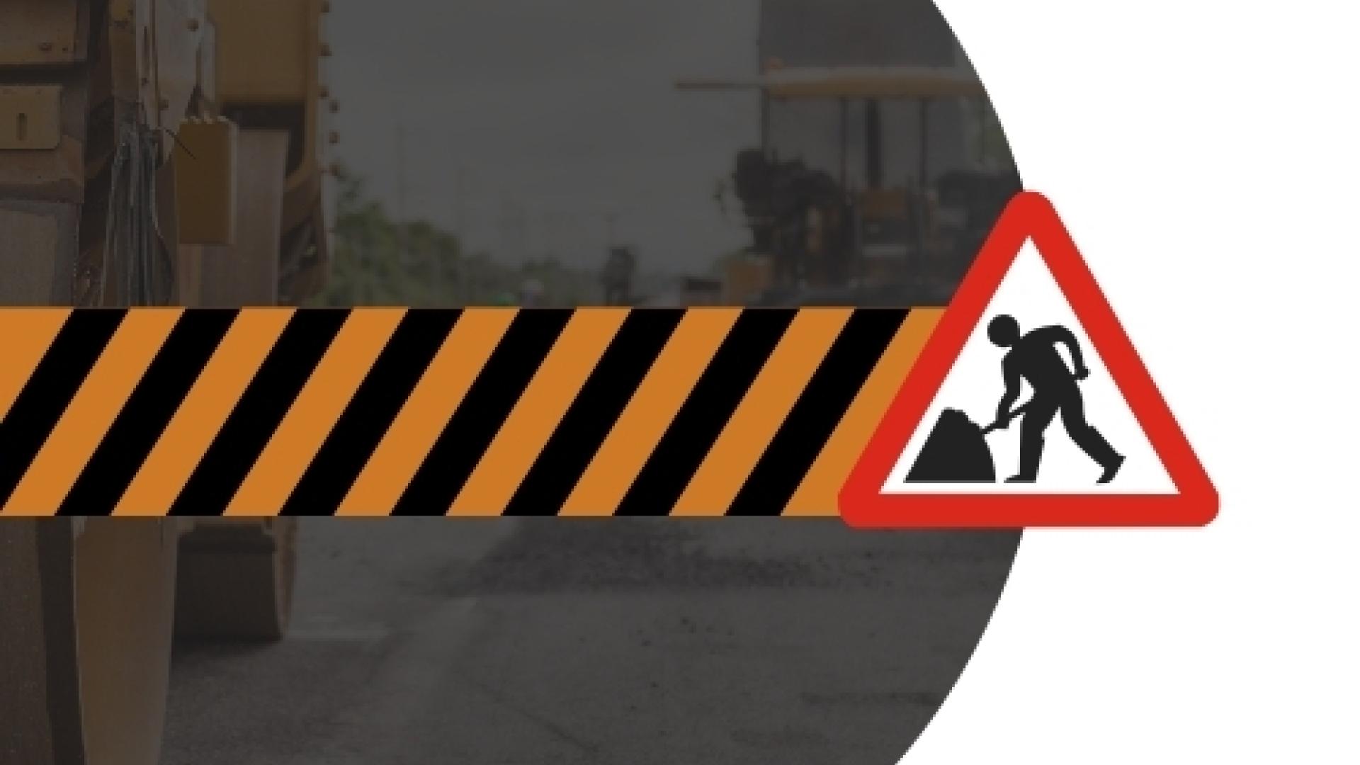 Road construction graphic featuring black and orange hazard stripes with a roadwork warning sign over a faded background of heavy construction equipment.
