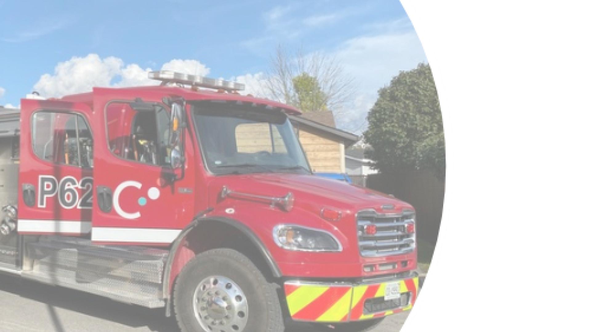 A red fire truck displayed inside a circular frame