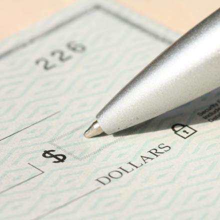 Pen filling out a cheque