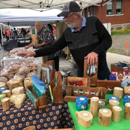 men selling items during a may show under a tent on the stree