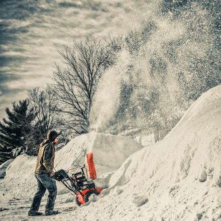 men snow blowing a big amount of snow