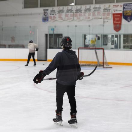 three hockey players on the ice playing hockey