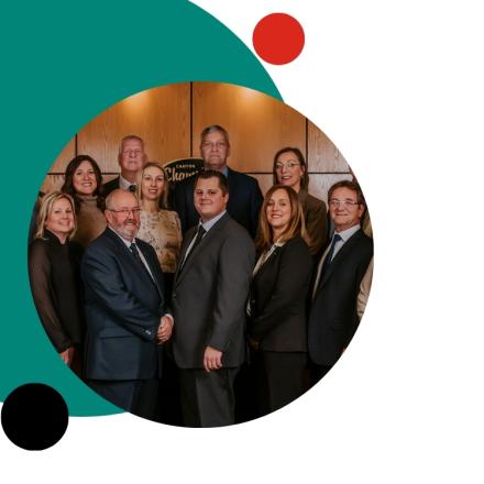 Professional group portrait of ten team members posing together.