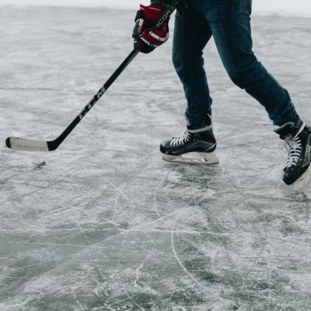 someone playing hockey on an outdoor rink