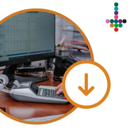 Computer workstation displaying financial software, with a calculator and office desk accessories