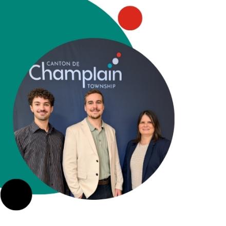 Three new employees standing in front of a black backdrop