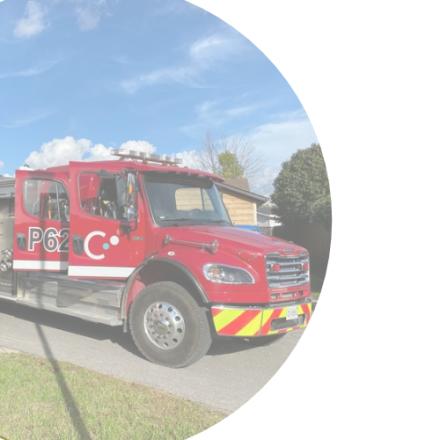 A red fire truck displayed inside a circular frame