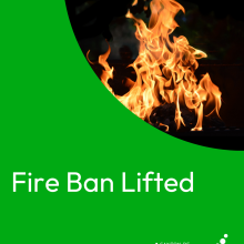 Fire ban lifted notice with flames in the background.
