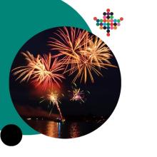 Fireworks bursting over a body of water at night, reflected on the surface, framed inside a circular photo with teal and black graphic accents. The Township of Champlain logo appears in the upper right corner.