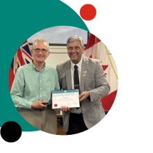 a men receiving an award from the Mayor Normand Riopel
