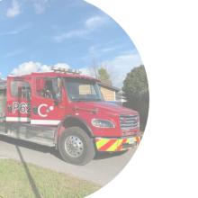 A red fire truck displayed inside a circular frame