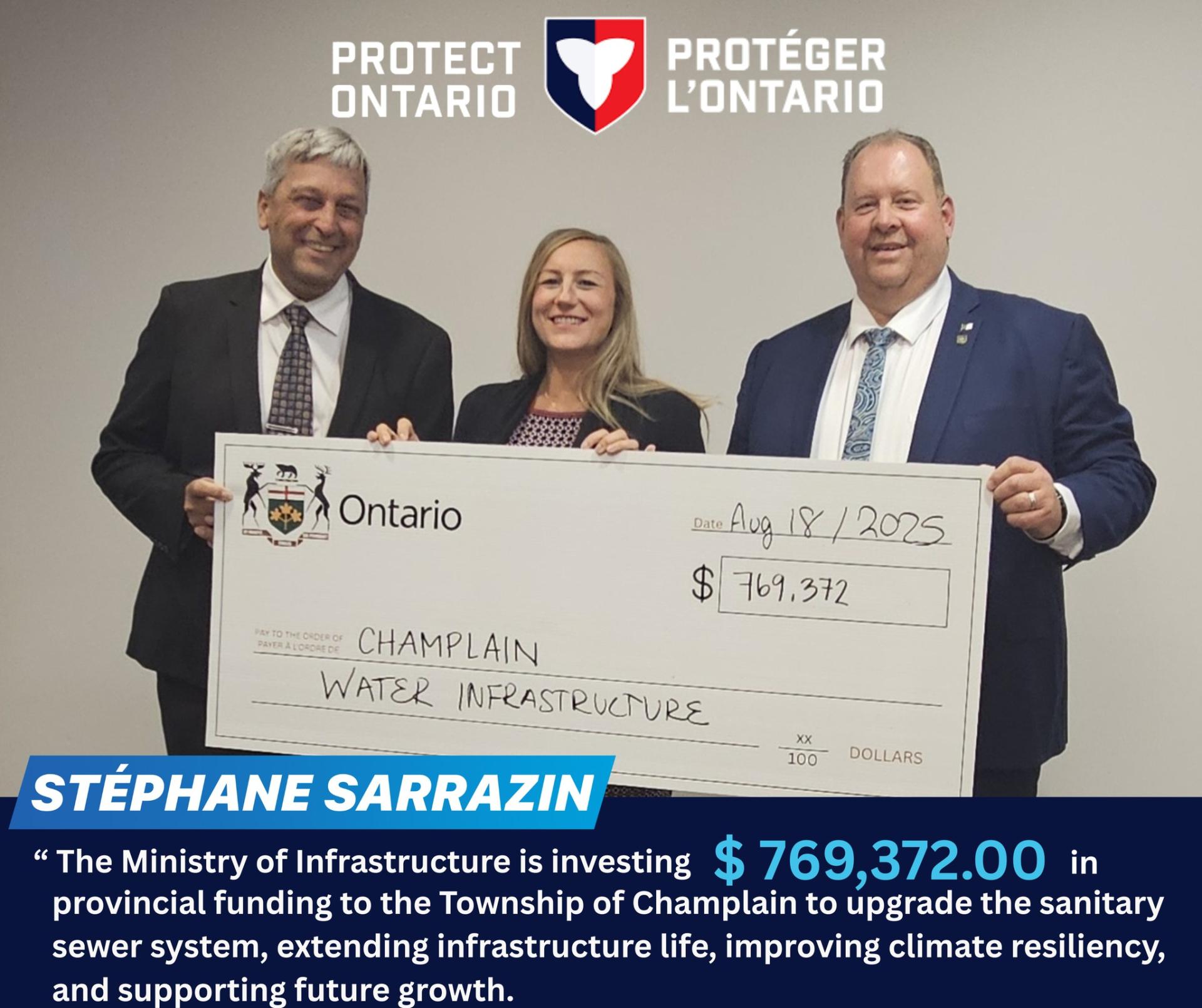 Three people smiling, holding a large cheque for Champlain Water Infrastructure.